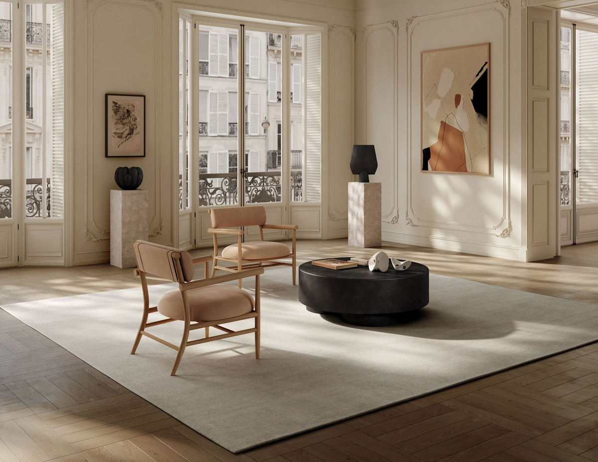 Big Foot coffee table and Nama lounge chairs in a living room