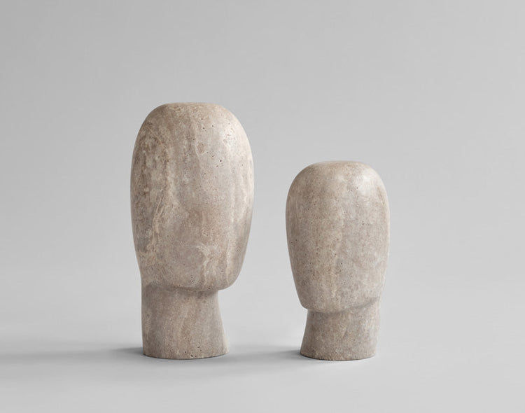 two calm sculptures in Silver Travertine, depicting abstract silhouettes of a neck and head. 