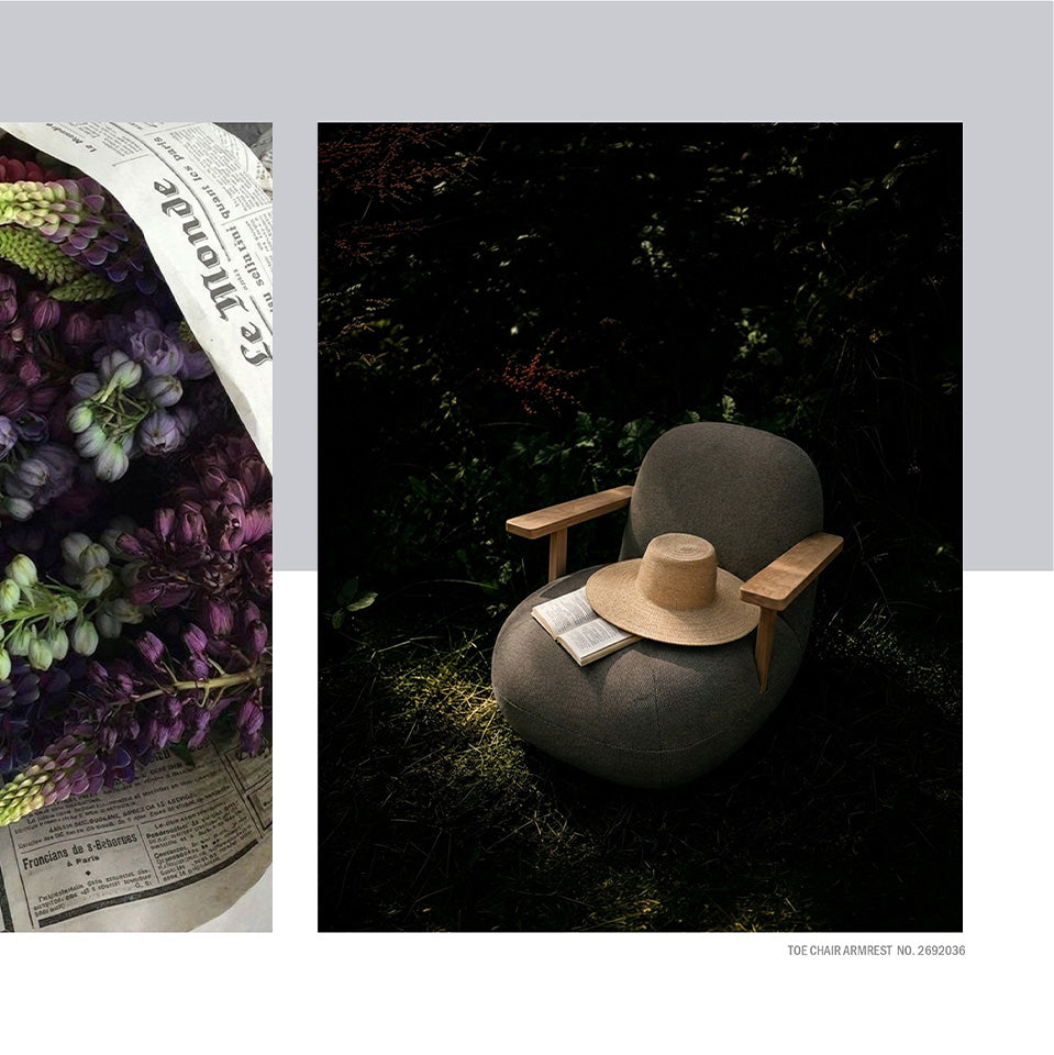 A styled editorial layout showing two scenes: on the left, purple flowers wrapped in newspaper; on the right, a round gray Toe chair in a dark outdoor setting with a straw hat and book resting on it. Small text at the bottom right reads 'Thoe chair armrest.