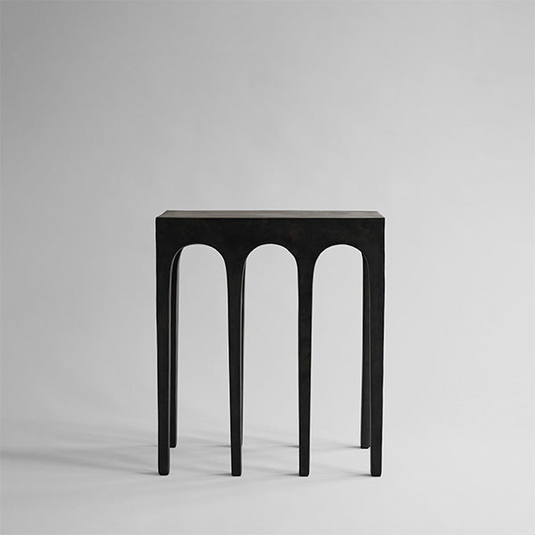 Coffee Bow side table with arch-shaped legs on a gray background