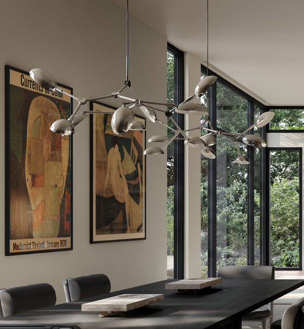 Drop Chandelier in Chrome over an Arc Dining table with Oka Trays 