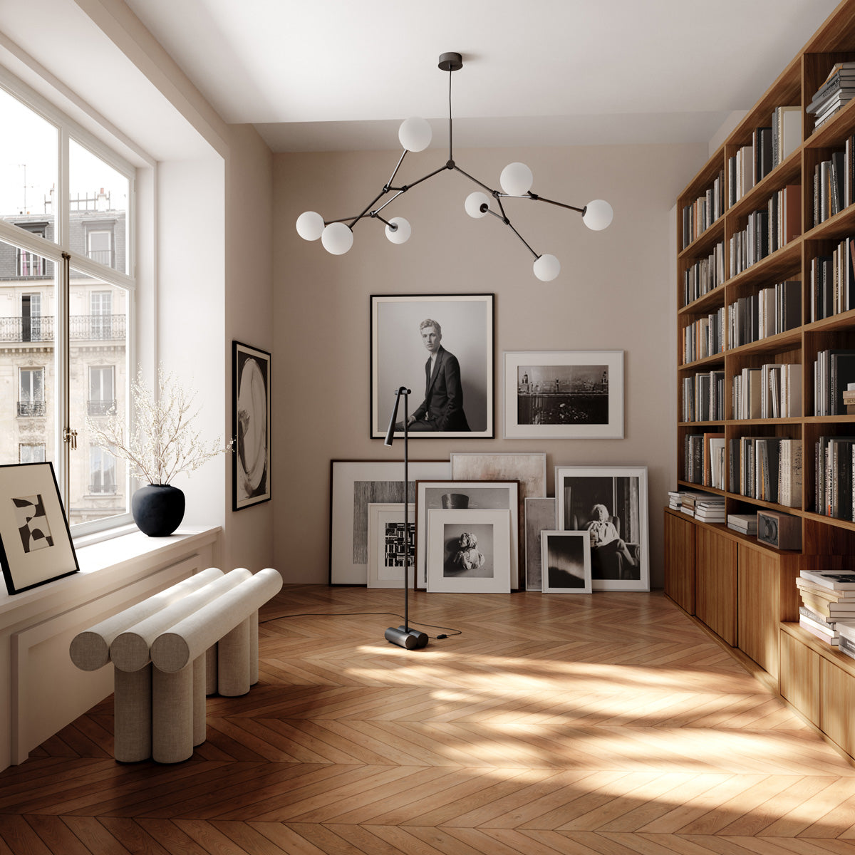 Modern living room with bookshelves, artwork, a Hiro Bench and a Drop chandelier Bulp, Sunao Vase and Snake floor lamp.