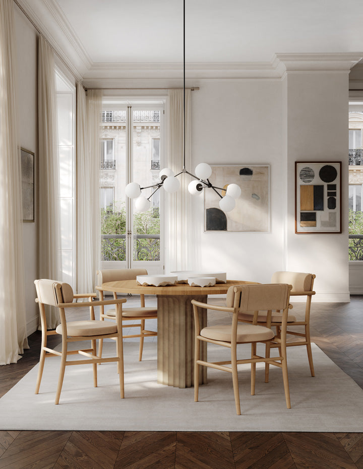 101 Copenhagen dinning room With round Ark Dining table, Drop Chandelier Bulp. Iwa trays, and Nama Ding chairs with armrests in Nubuck leather 