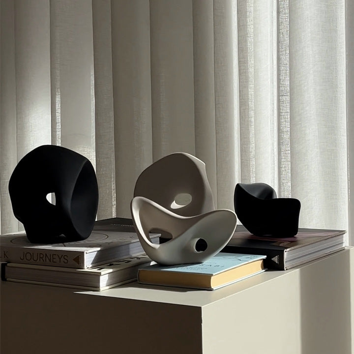 four Ori sculptures on books