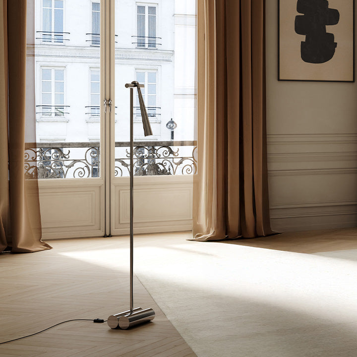 Modern Snake floor lamp in a stylish room with large windows and curtains.