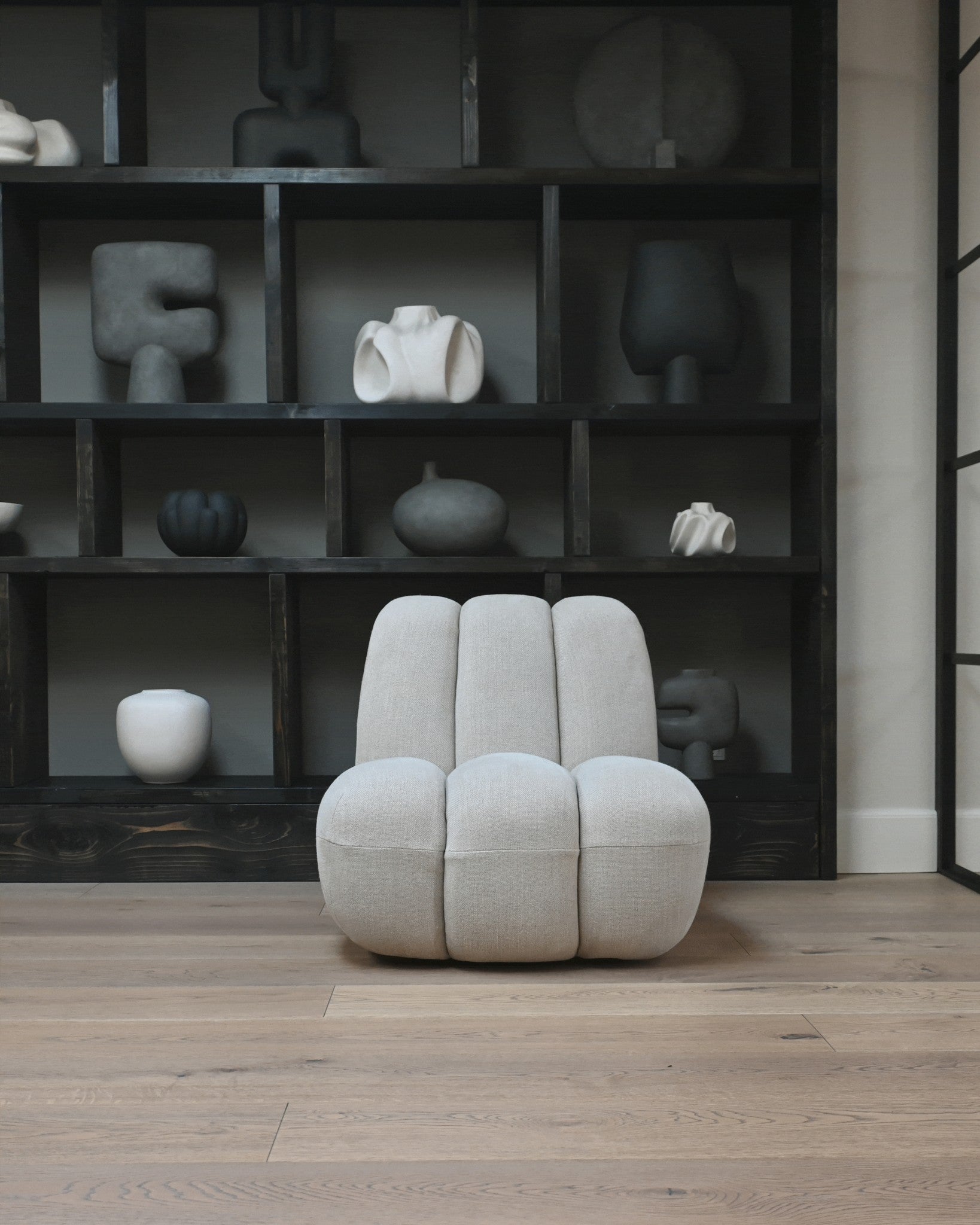 101 Copenhagen Toe Chair in Sand linen Colour 8047-2 in front of bookcase with vases