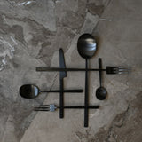 101 Copenhagen Kogei Salad Servers and cutlery - Black on light marble