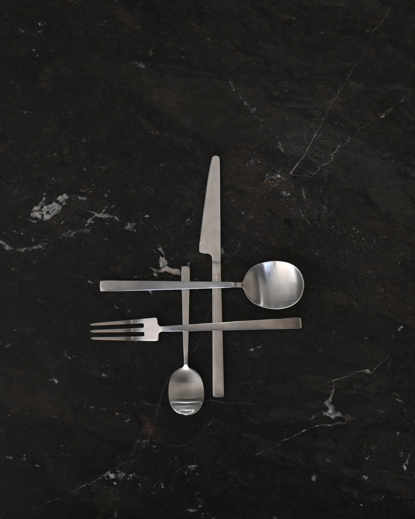 101 Copenhagen Kogei Cutlery - Brushed Steel on dark marble