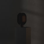 101 Copenhagen Clam Table Lamp - Burned Black turned on and off