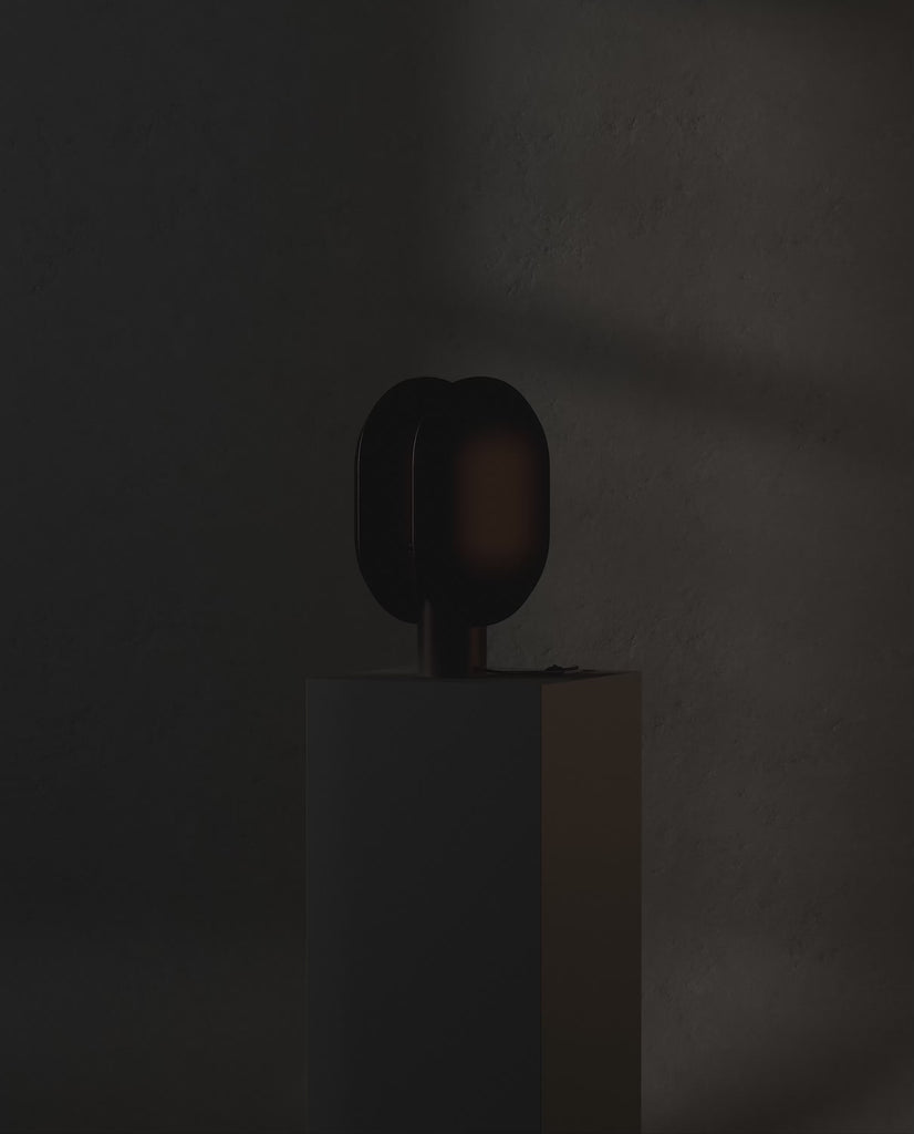101 Copenhagen Clam Table Lamp - Burned Black turned on and off