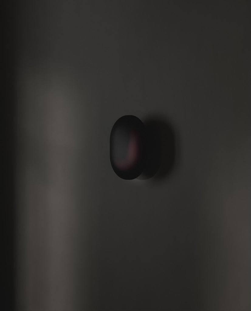 101 Copenhagen Clam Wall Lamp -  Burned Black turned on and off